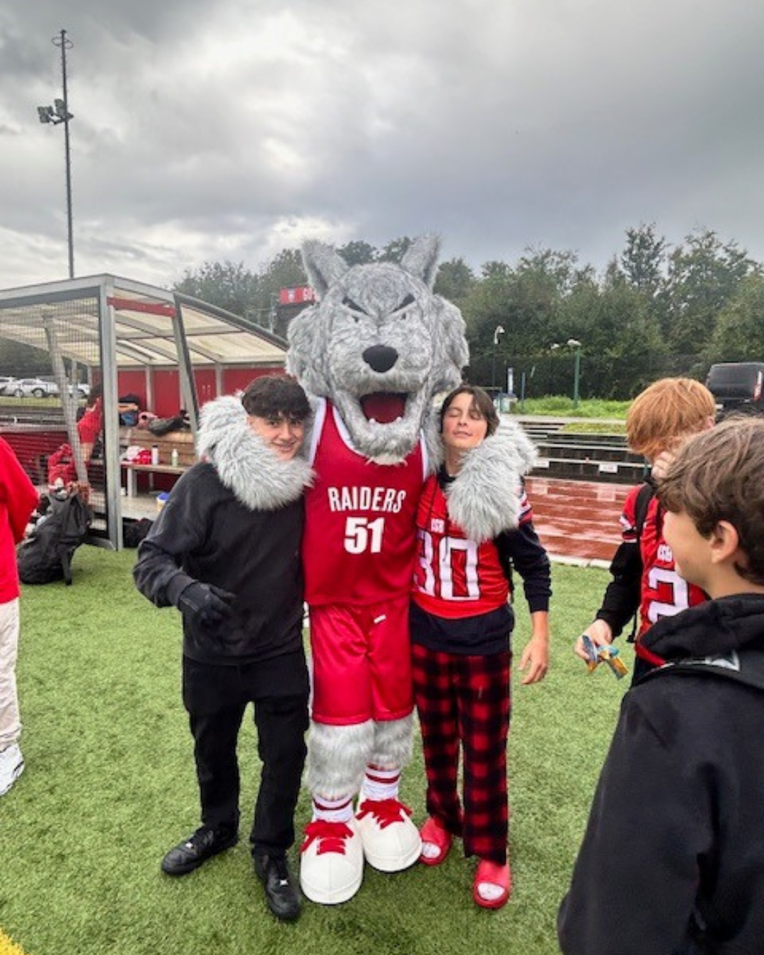 Loup with Raiders fans on the field