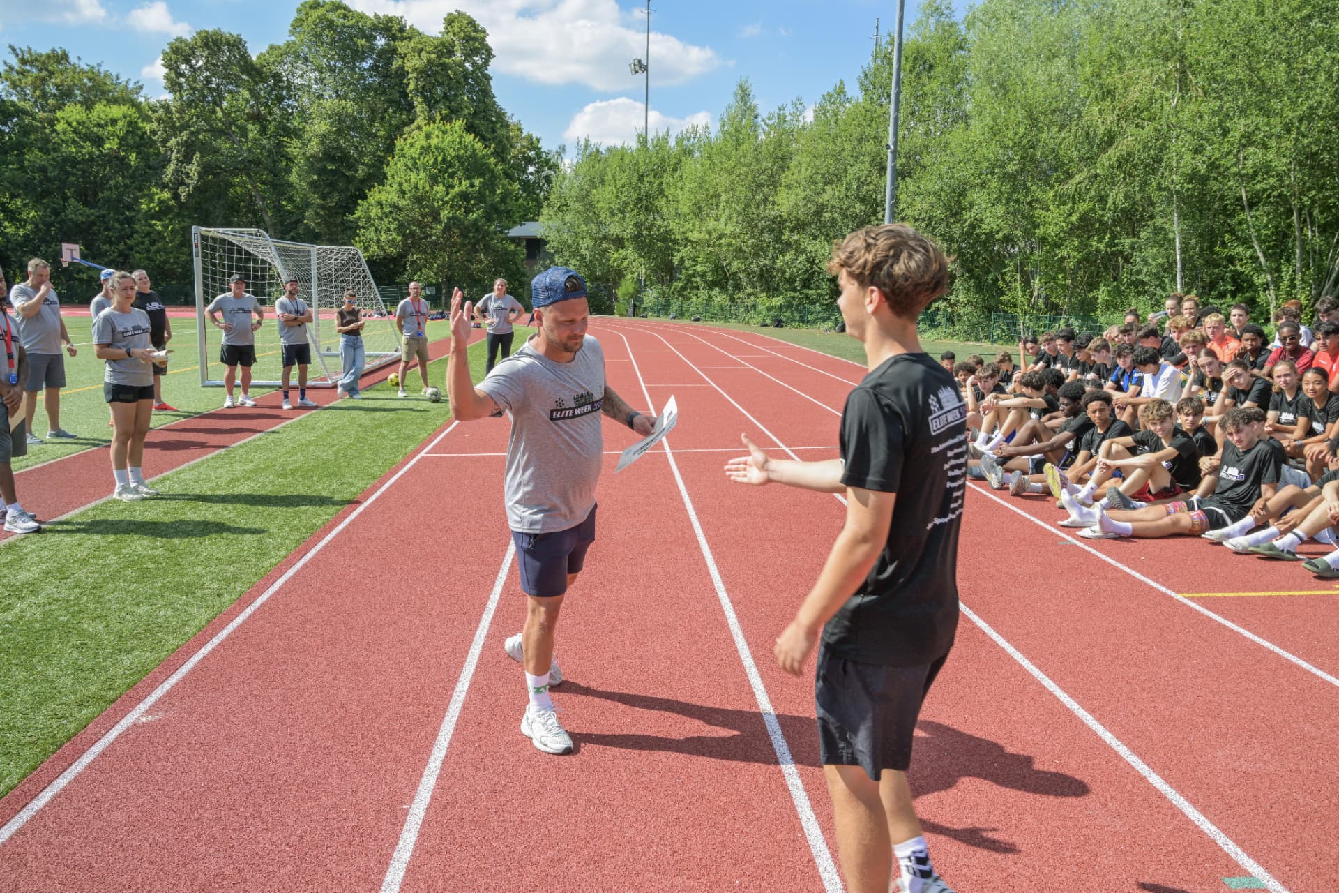 Coach greeting an athlete on the track