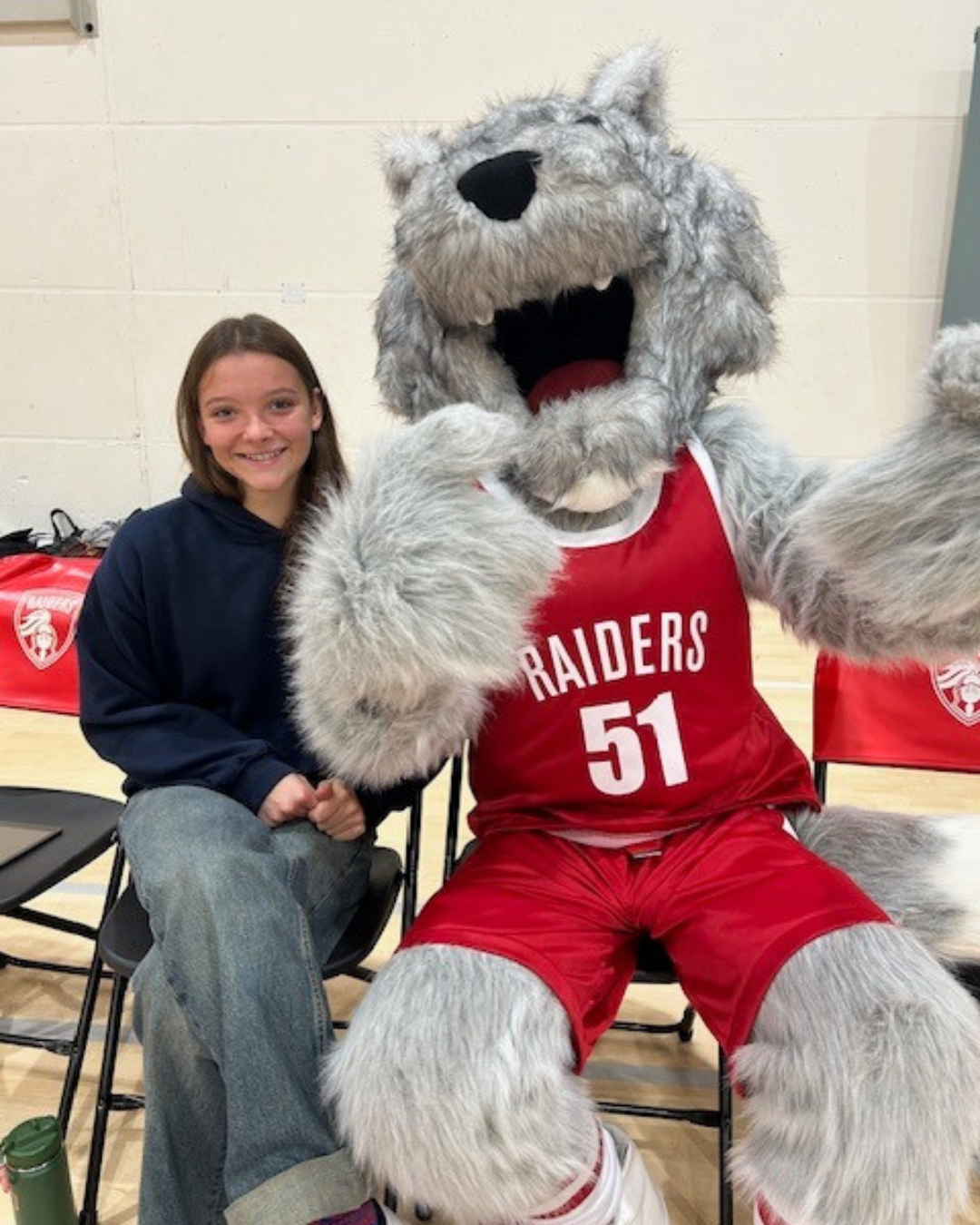 Loup courtside with a Raiders fan