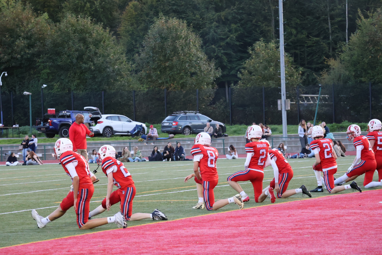 Raiders players warming up on the field