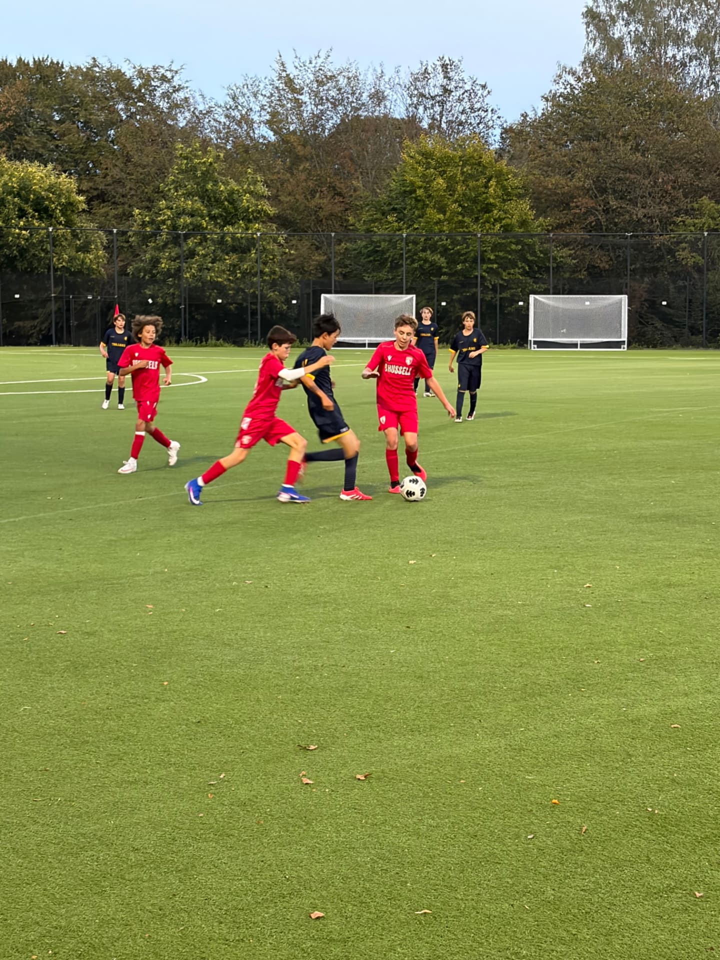 U14 boys soccer players competing for the ball