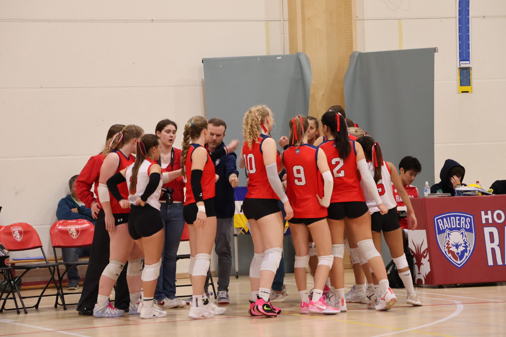 Varsity Girls Volleyball team huddle