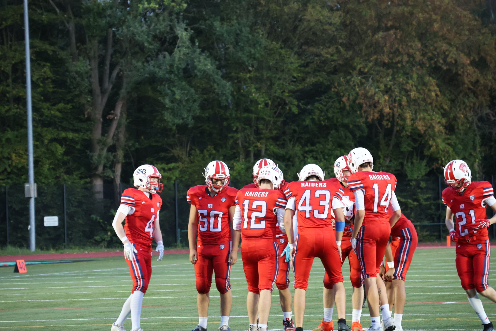 Raiders Football team huddle