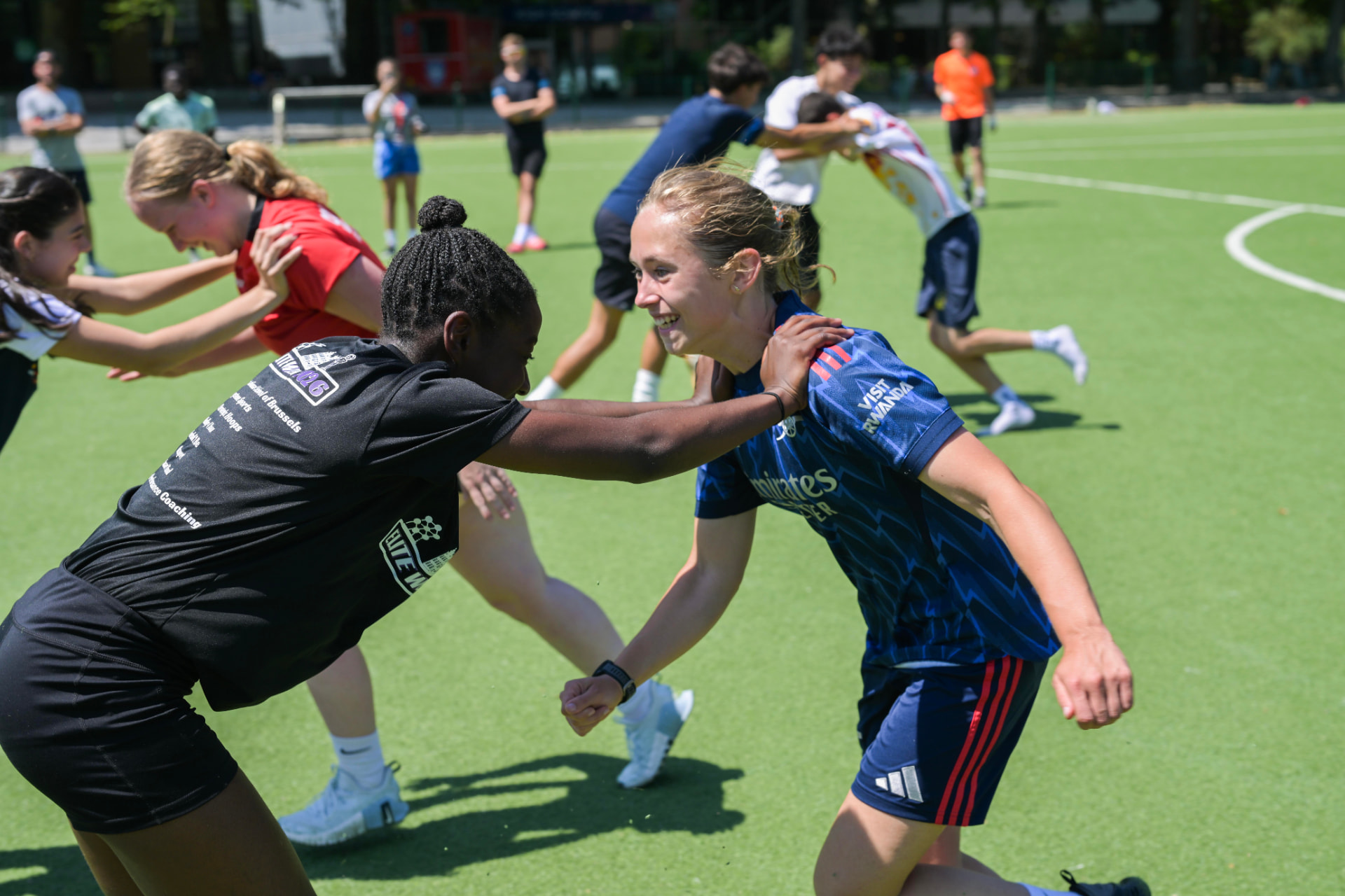 Soccer coach running a warm-up drill with athletes