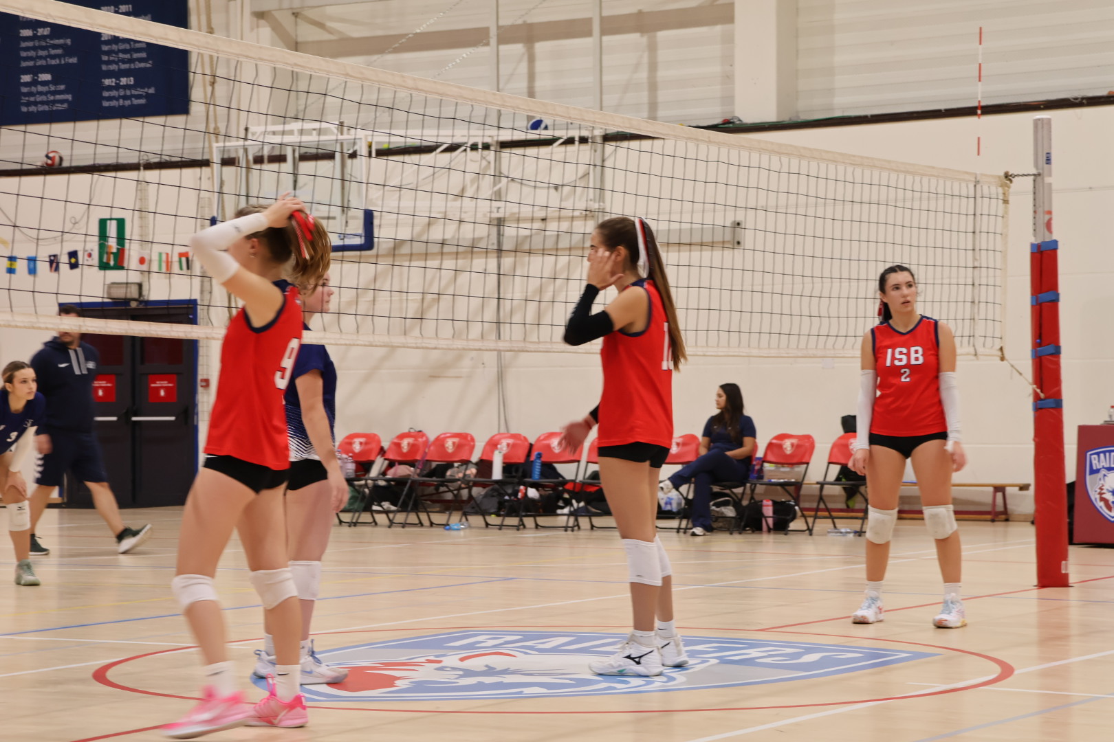 Raiders volleyball players preparing at the net