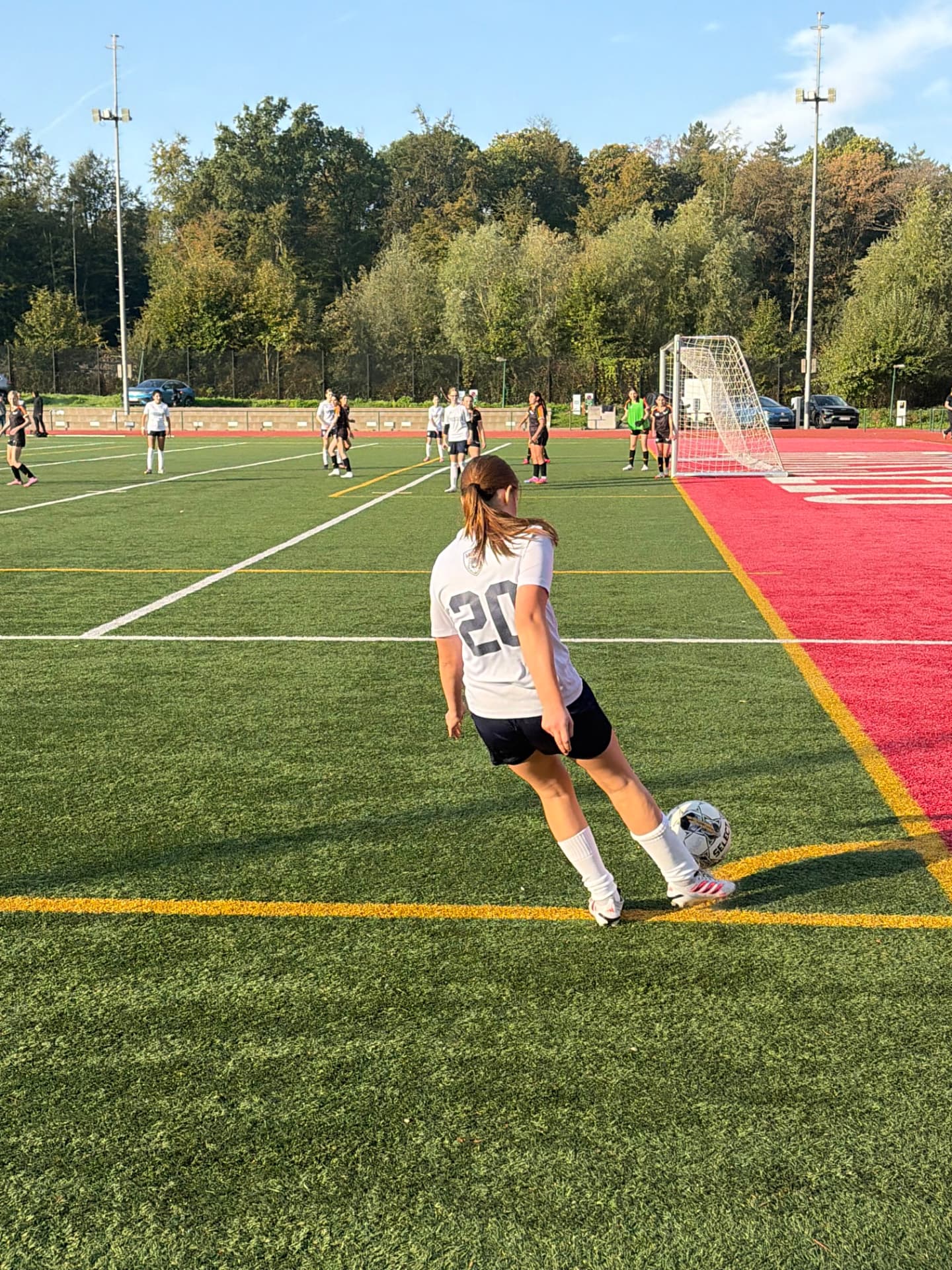 U14 girls soccer player taking a corner kick