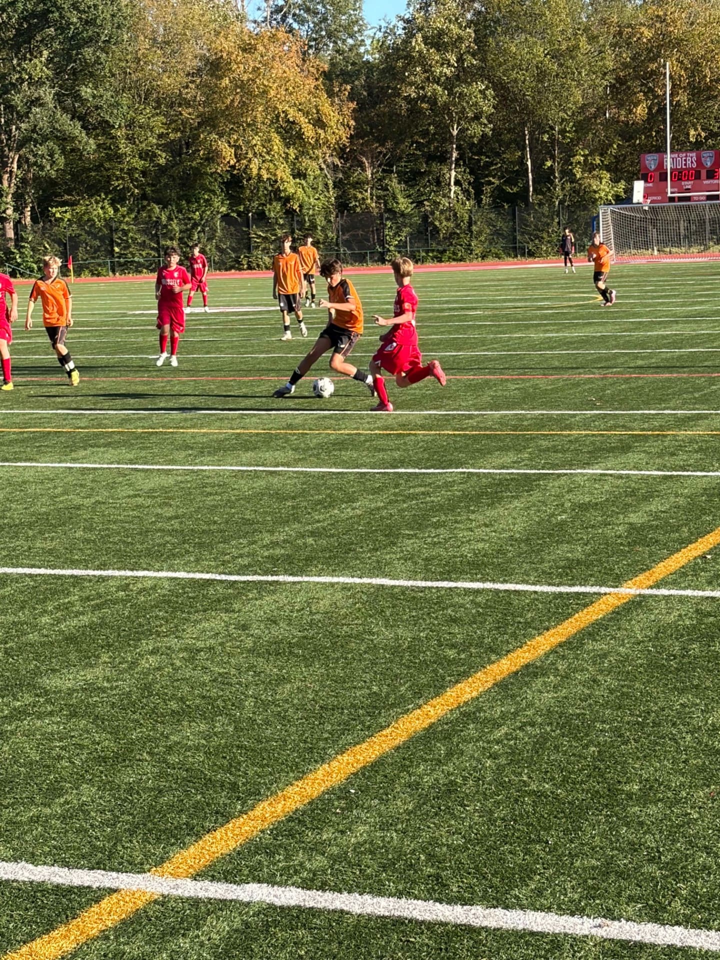 U14 boys soccer player challenging for the ball